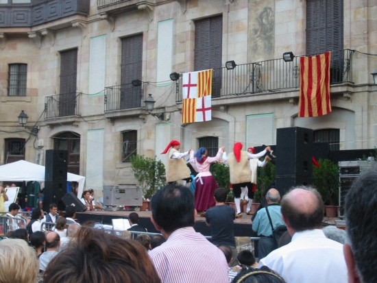 Some Catalan dance on a stage in the center of Barcelona
