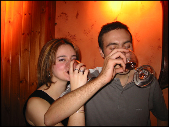 What is he looking at, at the bottom of his glass?