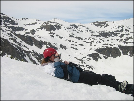 Francis lying down in the snow, filming